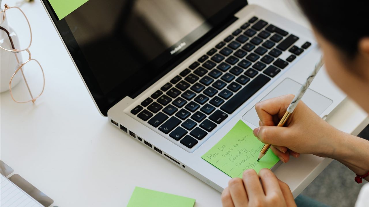 Website structure planning with sticky notes and laptop