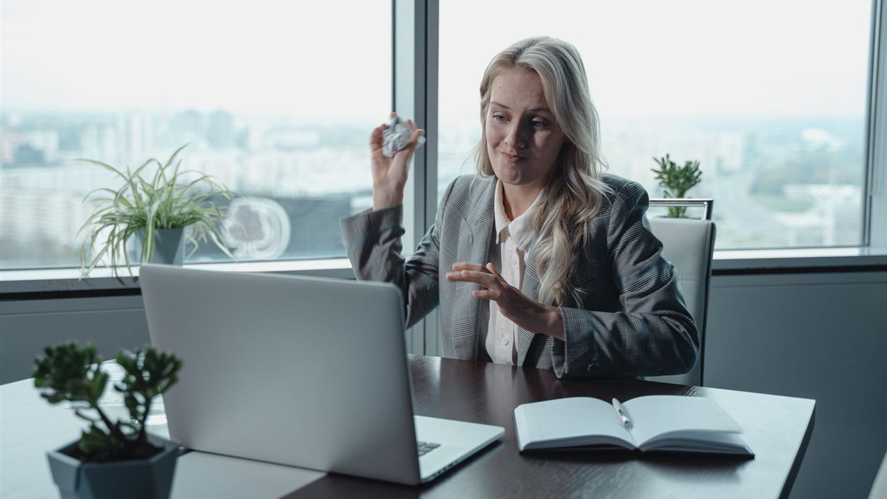 Frustrated business owner using a laptop while reviewing website problems